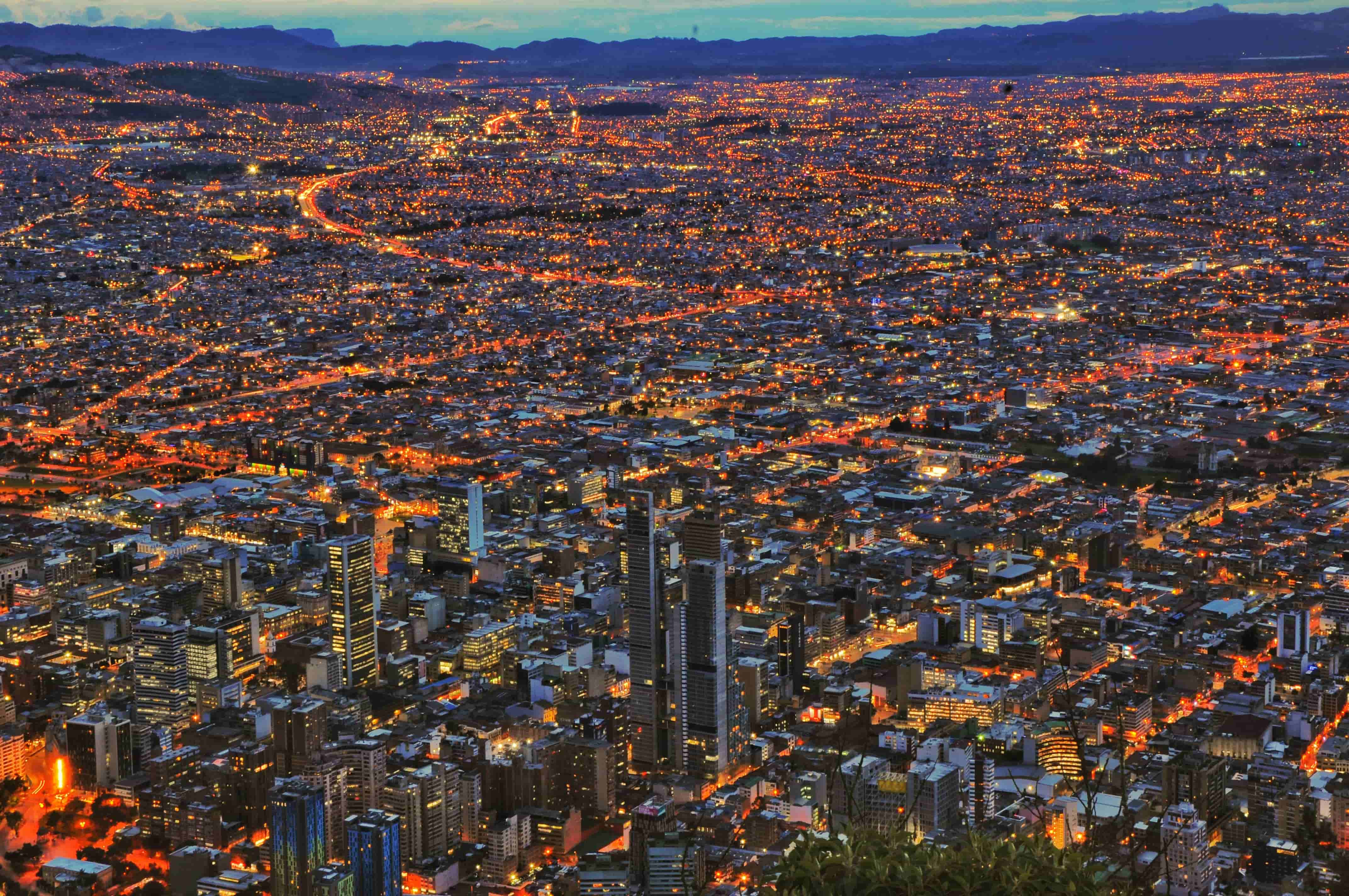 Night view of Bogotá with city lights traffic and tall buildings showing the capital of Colombia.