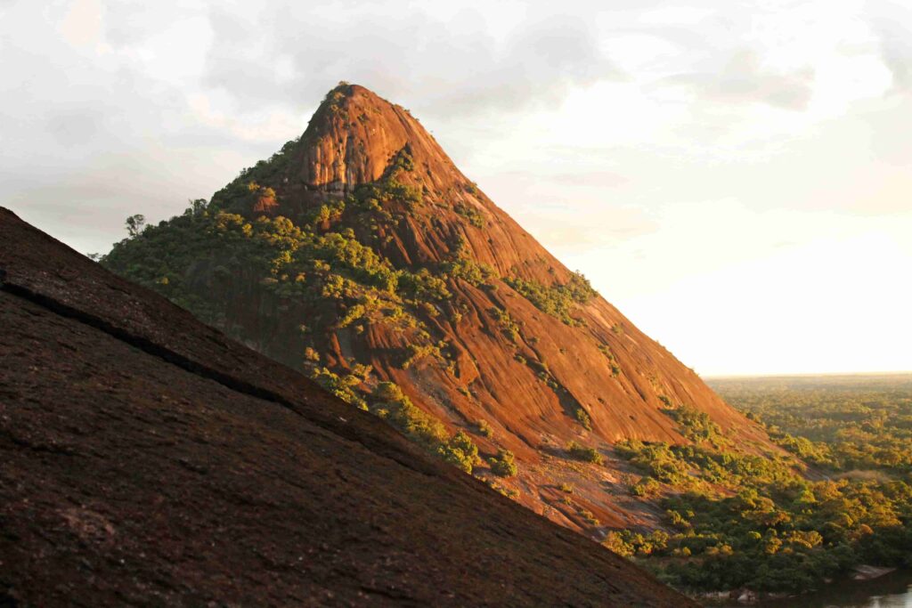 View from one of the Mavecure Hills with another hill and sunset over the Amazon landscape in Inirida, Colombia