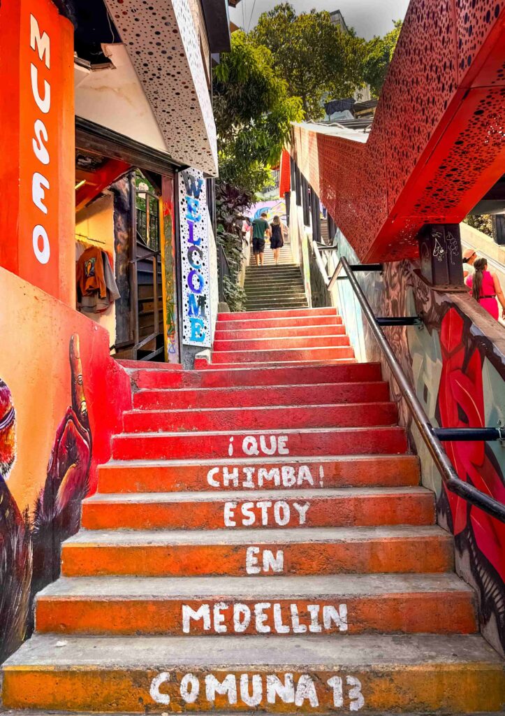 Painted stairs with Spanish welcome words in Comuna 13, Medellín, Colombia.