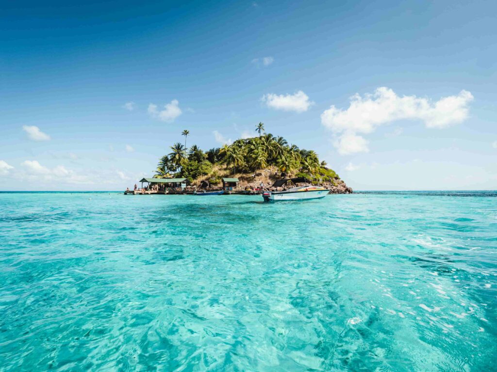 Providencia island with crystal clear water, palm trees, and small boats, San Andres, Colombia.